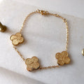 Gold clover bracelet with sabr, shukr and tawakkul written in Arabic calligraohy on each clover